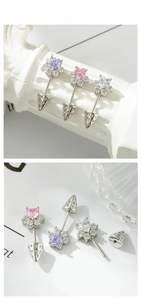 Detailed close-up of heart-shaped zircon earrings with paw cone backing in three colors