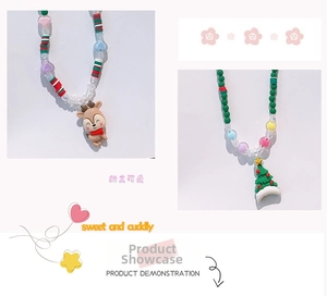 Detail of Christmas beaded necklaces featuring brown reindeer and green tree pendants