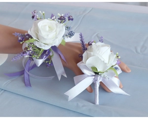 Detailed set of white rose and purple lavender wrist corsage and groom boutonniere
