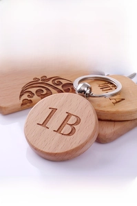 Macro detail of round beech wood keychain with custom engraved numbers and metal ring