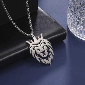 Silver lion head hollow pendant necklace with chain on leather display backdrop