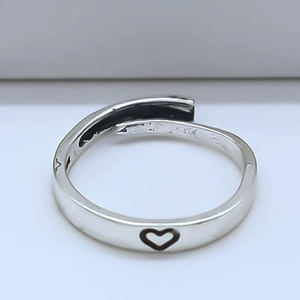 Macro shot of S925 sterling silver ring with hollow heart design and adjustable opening
