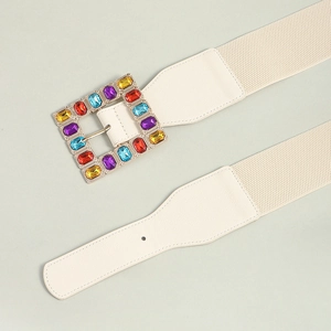 Macro detail of white elastic waist belt featuring a colorful gemstone square buckle