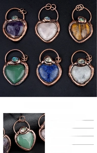 Detail view of heart-shaped vintage stone pendants with size and weight specifications