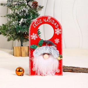 Close-up of wooden Christmas door hanger with Santa face and Feliz Navidad text