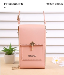 Close-up of pink pebbled leather phone bag with a golden flower magnetic buckle