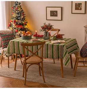 Christmas tablecloth with reindeer and snowflake patterns on a festive wooden dining table