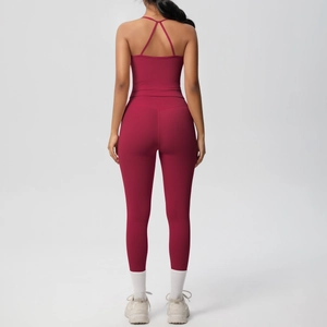 Rear view of burgundy backless yoga set featuring high waist leggings and cross strap top