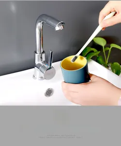 Close-up of a modern two-tone matte blue and yellow plastic cup under a bathroom faucet