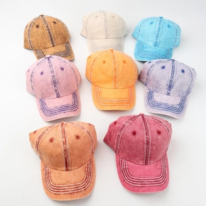 Top view of eight vintage washed cotton baseball caps in various pastel colors