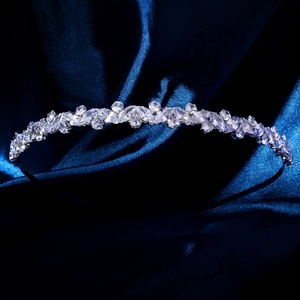 Detailed close-up of a silver crown headband with marquise zircons on blue silk