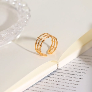 Close-up of three-layer 18k gold plated stainless steel open ring with bamboo texture