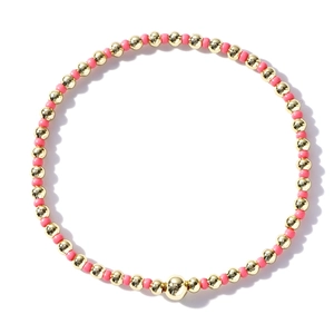 Elastic beaded bracelet featuring mixed pink beads and polished gold metal balls