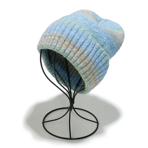 Detailed knit texture of light blue and yellow gradient winter beanie with folded cuff