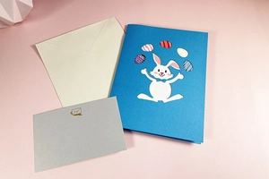3D Easter popup card set with blue rabbit cutout design and matching beige envelope