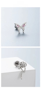 Detailansicht der silbernen Schmetterling-Ohrringe mit rosa Steinen und Schleife