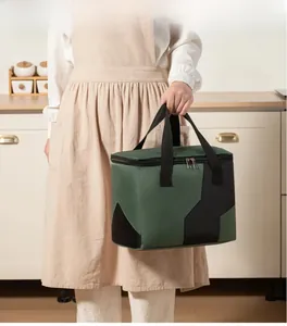Portable insulated lunch bag with reinforced handles shown in a home kitchen setting