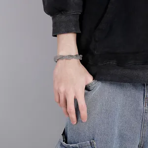 Detail of a men's silver snake bone weave bracelet on wrist with a street fashion style