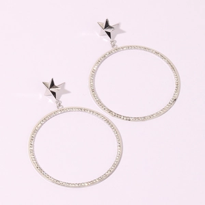 Macro shot of sparkling silver star stud earrings with large crystal-encrusted hoops