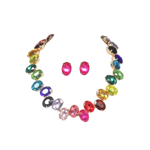 Rainbow gemstone jewelry set featuring colorful oval crystals and golden metal finish