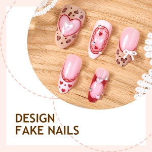 Pink and leopard print press-on nails with 3D bows, hearts and pearls on wood background