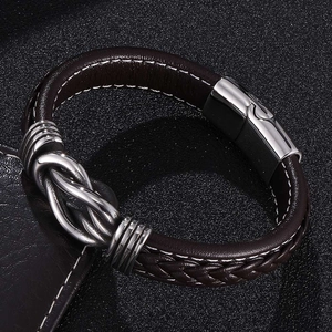 Detail of dark brown braided leather bracelet with silver magnetic clasp for men