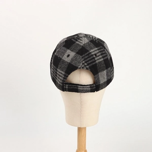 Detail view of the gray plaid wool baseball cap showing adjustable back strap and stitching
