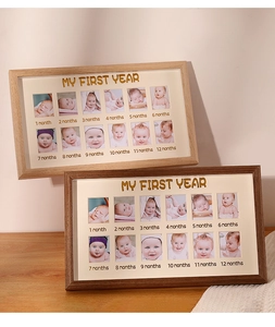 Macro view of my first year wooden baby frames with twelve photo slots and gold text