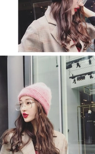Close-up of pink gradient knit beanie paired with a classic plaid jacket for autumn