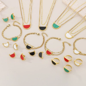 Flat lay of colorful acrylic and gold titanium steel jewelry set with marble accents