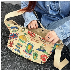 Close-up of beige canvas crossbody bag with vintage American style prints and texture