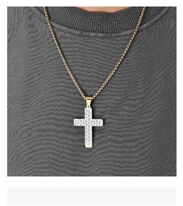 Close-up of a two-tone honeycomb hollow cross pendant necklace on a male model