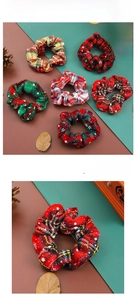 Detail of Christmas plaid scrunchies with white snowflake patterns and festive colors