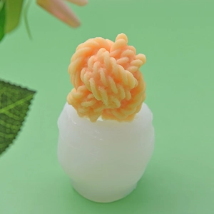 Yarn ball silicone mold for DIY soap or candles showing mold and finished orange product