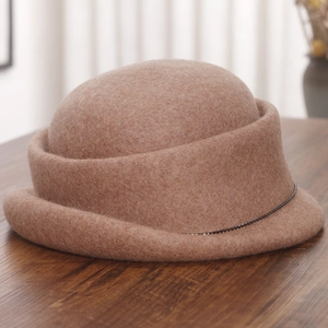 Detail of wool cloche hat with elegant rolled edge and decorative delicate metal chain