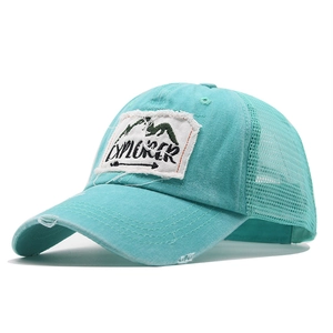 Detailed view of mint green explorer hat showing distressed fabric and mesh texture