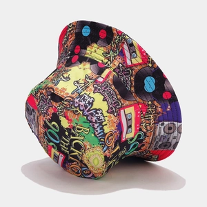 Top-down view of a reversible bucket hat featuring 90s graffiti art and retro patterns