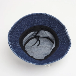 Detail of dark blue denim bucket hat interior featuring black sweatband and adjustable drawstring