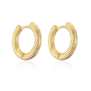 Macro shot of textured gold-plated hoop earrings featuring a unique metallic pattern