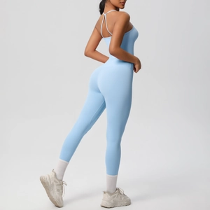 Detail of cross-back straps on light blue yoga jumpsuit for athletic workouts
