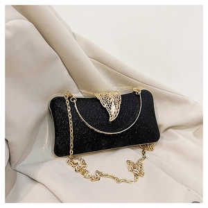 Detail of black glitter evening clutch with gold hollow clasp and metal ring handle