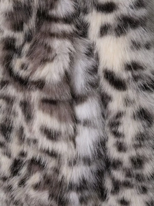 Close-up of black and white animal print faux fur texture with soft fluffy fibers