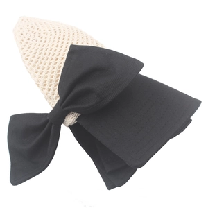 Foldable beige straw sun hat for women featuring a large black bow for summer beach travel