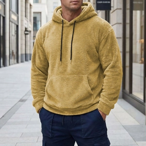 Detail of ginger yellow fleece hoodie featuring fuzzy texture and a kangaroo pocket