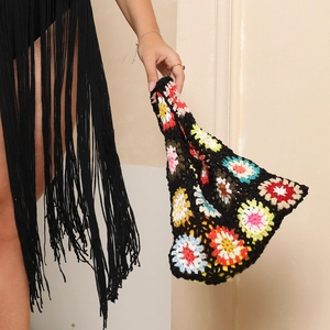 Detail of handcrafted crochet tote bag featuring colorful retro bohemian floral patterns
