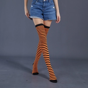 Detail of orange and black striped over-knee socks with elastic knit texture