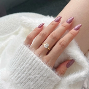 Detail of s925 silver gold ring featuring a rectangle cut gemstone on a finger