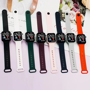 Flat lay of colorful digital sport watches with LED display and silicone straps on purple background