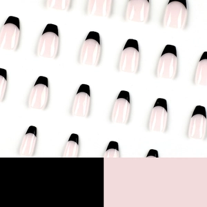 Short ballet press-on nails featuring light pink base and glossy black French tips