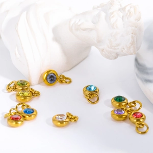 Macro shot of assorted colorful zircon stones set in golden stainless steel charms